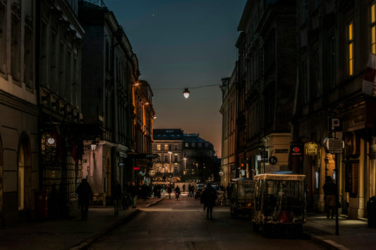 An empty city street between buildings at dusk, the quiet hour after an evening training session