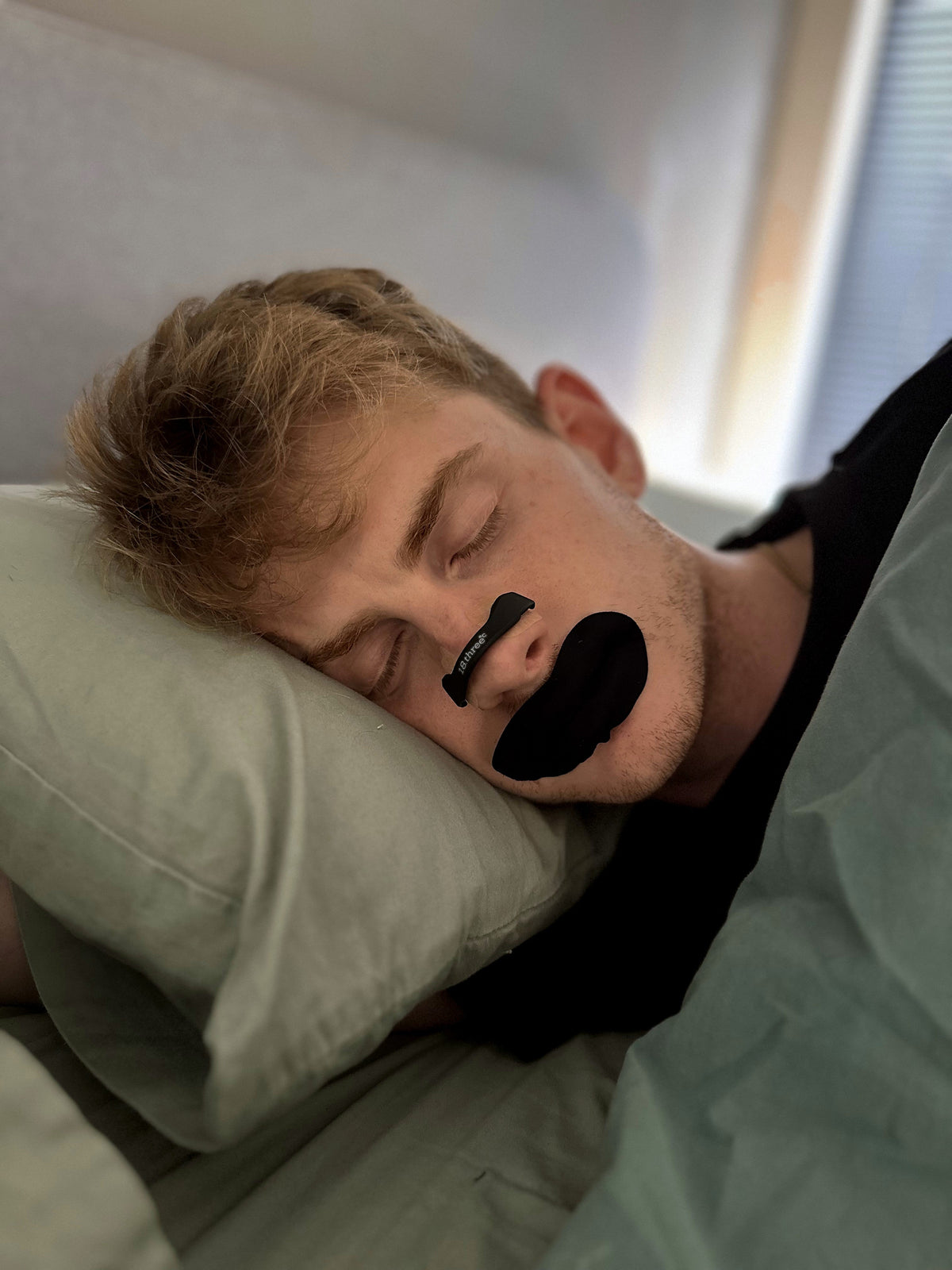 Sleeping wearing the 18pointthree Magnetic Nasal Strip and Mouth Tape