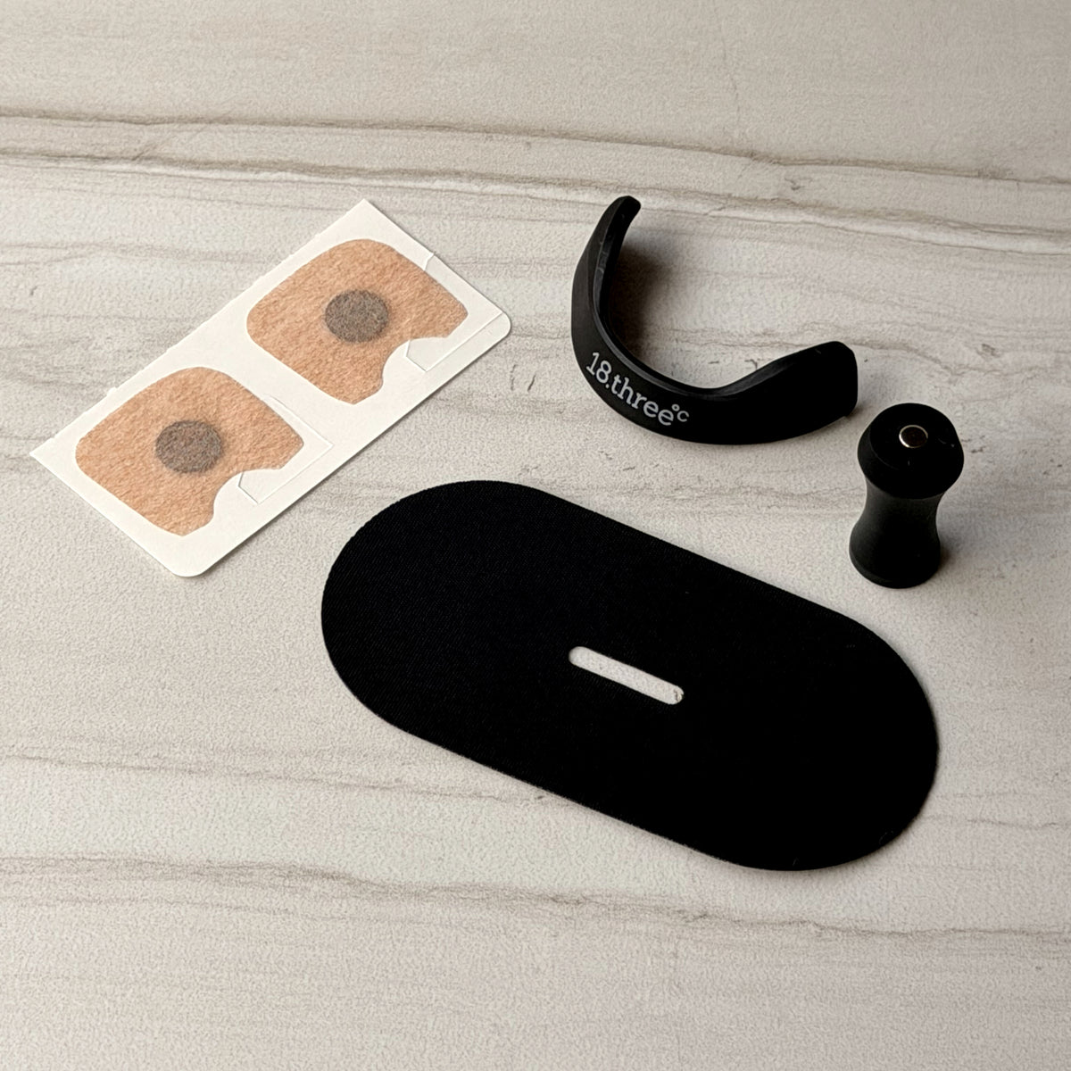 The magnetic nasal strip system laid out - reusable frame, magnet and adhesive patches