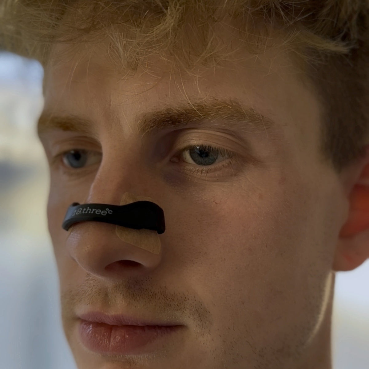 Close-up of the 18pointthree Magnetic Nasal Strip frame worn on the nose