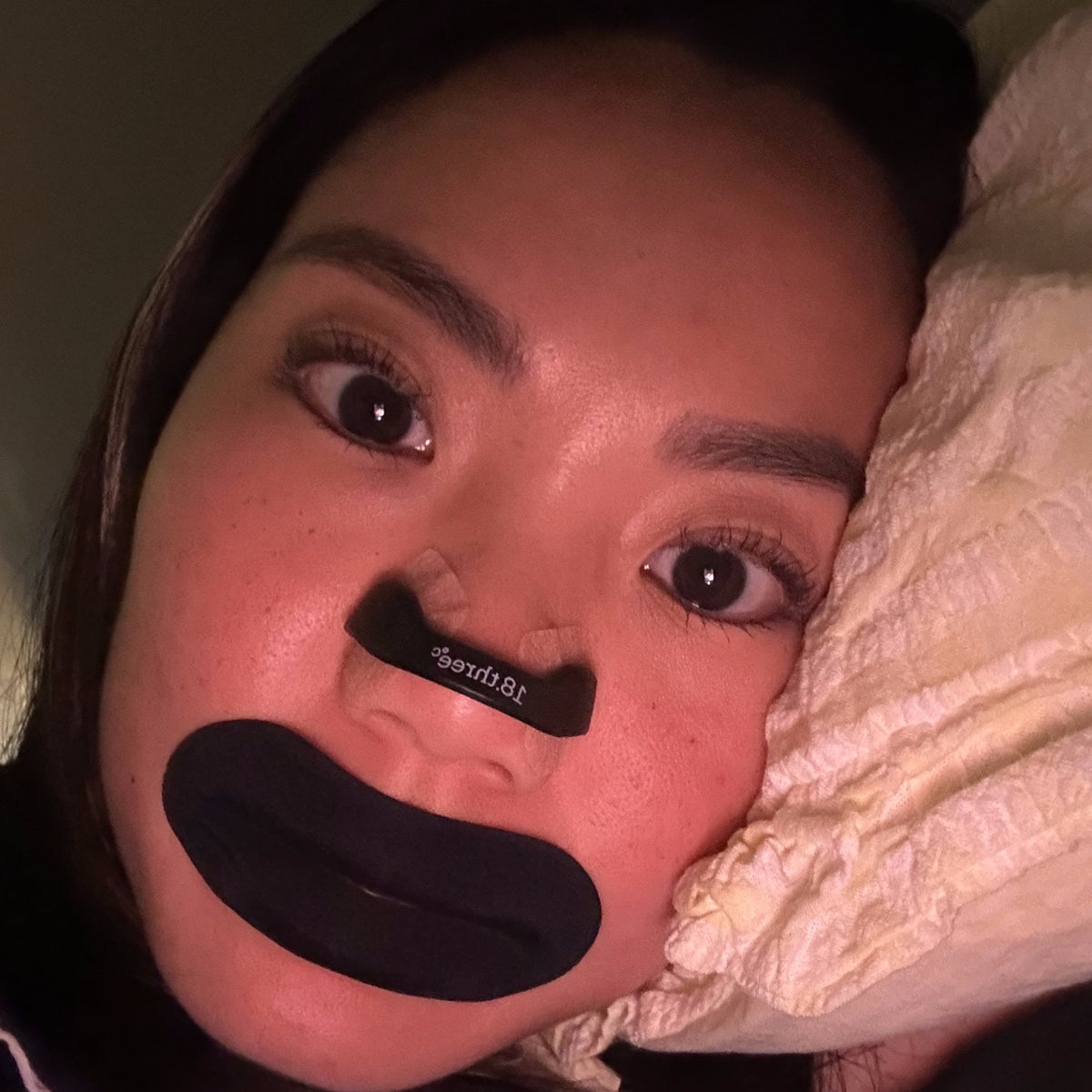 Man wearing an 18pointthree nasal strip and mouth tape before sleep